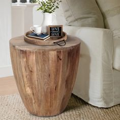 a wooden table sitting on top of a rug next to a couch