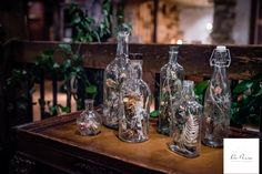 several empty glass bottles sitting on top of a wooden table