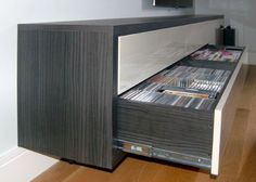 an entertainment center with several cd's in it