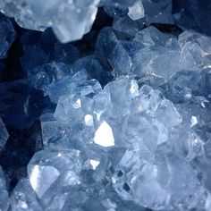 some ice crystals are sitting on top of each other in the dark blue hues