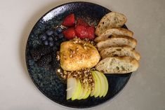 a blue plate topped with fruit and bread