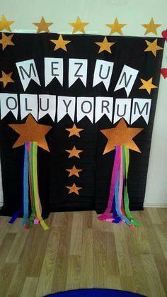 a bulletin board with stars and streamers in the shape of letters that spell, mezuv olluyorum