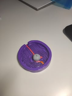 a computer mouse sitting on top of a purple object