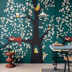 a room with a tree painted on the wall