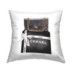 a black and white pillow with a chanel bag on it