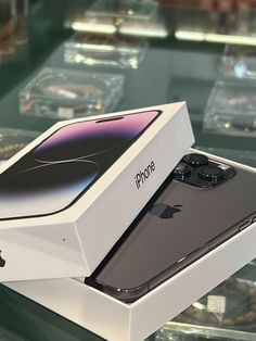 an iphone in a box sitting on top of a table