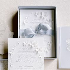 the wedding stationery is laid out on top of each other, including an open box