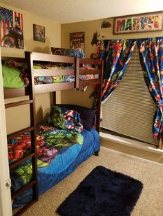 a bedroom with bunk beds and curtains on the window sill, carpeted floor