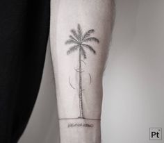 a person with a palm tree tattoo on their arm