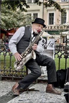 an old man is playing the saxophone outside