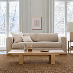 a living room scene with focus on the couch and coffee table in the foreground