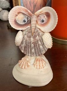 an owl figurine sitting on top of a wooden table