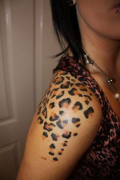 a woman's arm with leopard print on it and her hair in pony tail