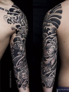 the back of a man's arm with tattoos on it and an image of flowers