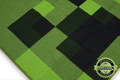 a green rug with black squares on it