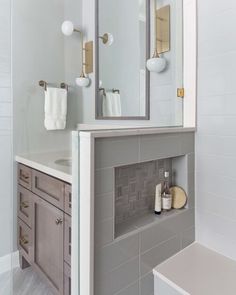 a bathroom with a sink, mirror and bathtub