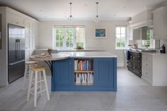 a kitchen with an island and bookshelf in it