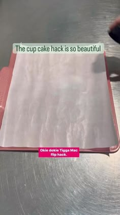 a piece of cake that is on top of a metal table with a sign reading the cupcake hack is so beautiful