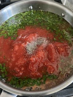 a pan filled with meat and sauce on top of a stove