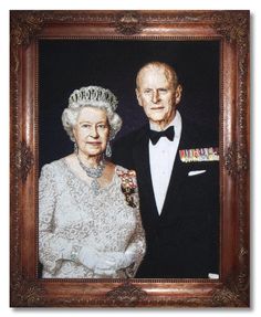 an image of the queen and prince of england on display in a wooden framed frame