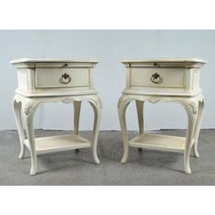 two white nightstands sitting next to each other