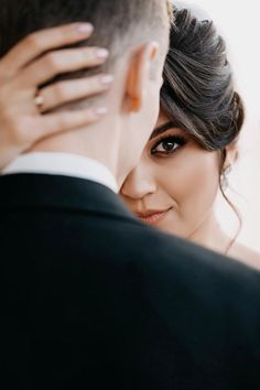 the bride and groom are looking at each other