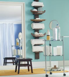 a bathroom with blue walls and white towels on the rack in front of the mirror