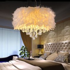 a bedroom with a chandelier hanging from the ceiling and a bed in front of it