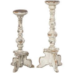 two white wooden candlesticks sitting next to each other