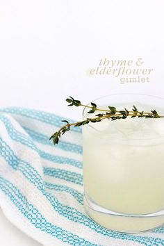 a glass filled with a drink on top of a blue and white towel