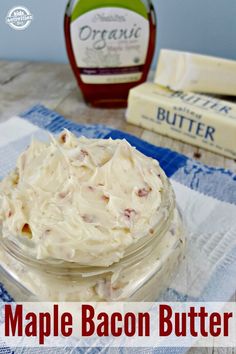 a jar filled with whipped cream sitting on top of a blue and white towel next to some butter