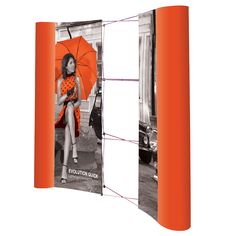 an orange roll up display with a girl holding an umbrella