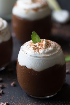 two dessert cups with whipped cream and chocolate