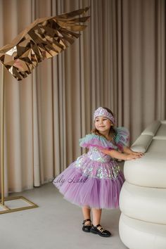 Make your little girl's birthday extra special with this gorgeous  Mermaid Dress! This stunning toddler birthday outfit features a beautiful mermaid-inspired design with a flowing lilac tutu skirt and a mermaid detail. The dress is perfect for any special occasion, including birthdays, cake smashes, and princess-themed parties. Made with high-quality materials, this baby girl tutu dress is soft, comfortable, and breathable, ensuring that your little one stays cozy and stylish all day long. Wheth Pink Tulle Mermaid Dress For Pageant, Pink Tulle Mermaid Dress For Pageants, Whimsical Mermaid Tutu Dress For Birthday, Whimsical Mermaid Dress For Party, Purple Fairy Dress With Ruffles For Birthday, Whimsical Purple Princess Dress For Birthday, Whimsical Purple Princess Dress With Ruffles, Pink Ruffled Mermaid Dress For Pageant, Pink Mermaid Dress With Ruffles For Pageant