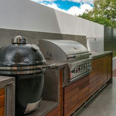 an outdoor kitchen with grill and counter space