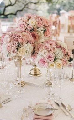 the table is set with pink and white flowers