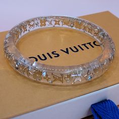 Rare Louis Vuitton Lucite Bracelet With Gold Signature Louis Vuitton Symbols And Lv All The Way Around The Bracelet. Never Worn. Comes In Box With Dustbag. Size Measured 8cm. See Pictures. Louis Vuitton Jewelry Bracelet, Louis Vuitton Jewerly, Louis Vuitton Fine Jewelry, Louis Vuitton Official Jewelry, Luxury Jewelry Box Louis Vuitton, Rare Louis Vuitton, Custom Fitted Hats, Lucite Bracelets, Louis Vuitton Jewelry