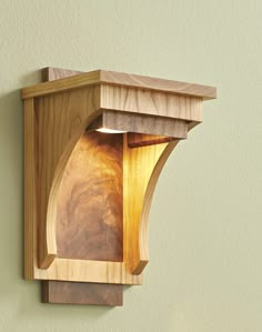 a wooden light fixture mounted to the side of a wall