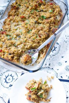 a casserole dish with meat and vegetables in it next to a fork on a plate