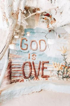 the words god is love are painted on an old wall