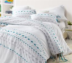 the comforter is white and has blue dots on it