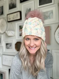 a woman with blonde hair wearing a white knitted hat