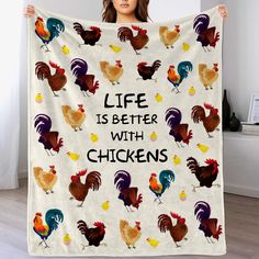 a woman holding up a blanket with chickens on it that says life is better with chickens