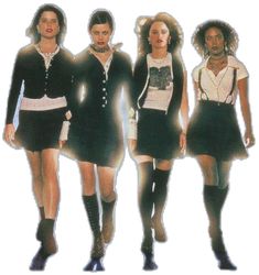 three women in short skirts and boots are walking down the runway with their hands on their hips