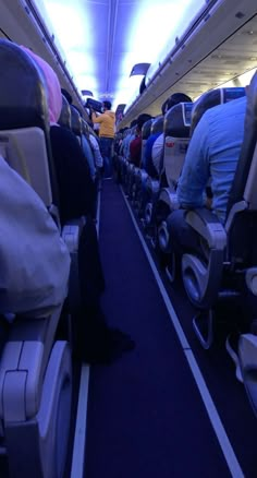 an airplane with people sitting on seats and facing the back row, all looking in different directions