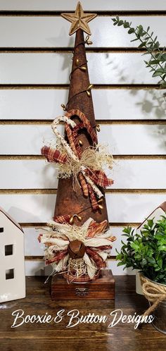 a wooden christmas tree sitting on top of a table