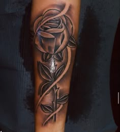 a black and white rose tattoo on the arm