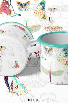 two mugs with colorful butterflies on them next to the same cup and saucer