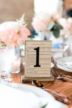 the table is set with silverware and flowers