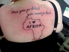 the back of a woman's shoulder with an african map and words on it